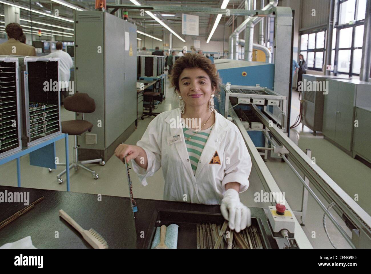 Berlin-Brandenburg / Industrie / Ausländer / 8/1993 Türkische Mitarbeiterin bei DeTeWe im Werk Hoppegarten bei Berlin. In der Fabrik werden Komponenten der digitalen Börsen der Telekom hergestellt. Die Produktion erfolgt fast vollautomatisch (siehe Fotos 1980, viel Handarbeit). Diese Frau mit Kopftuch steckt Leiterplatten ein // Turks / Arbeit / Elektronik [automatisierte Übersetzung] Stockfoto