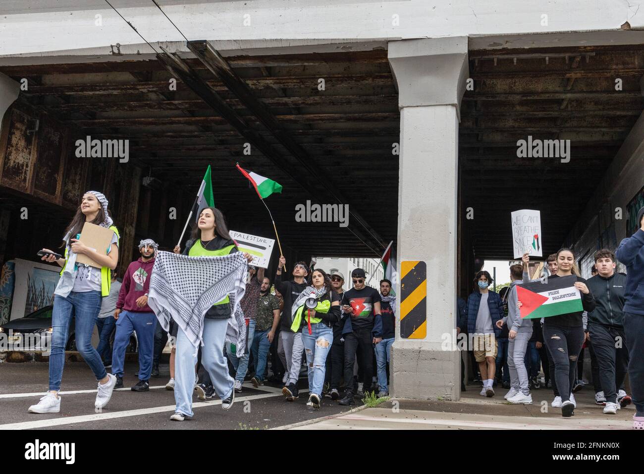Dayton, Usa. Mai 2021. Die Demonstranten marschieren unter einer Überführung mit traditionellen palästinensischen Keffiyeh-Tüchern und palästinensischen Fahnen. Demonstranten treffen sich auf dem Courthouse Square in Dayton, Ohio, um sich zu versammeln und gegen den israelischen Luftangriff auf Gaza und die Besetzung Palästinas zu marschieren. Nach Angaben des von der Hamas geführten Gesundheitsministeriums beträgt die Gesamtzahl der Todesopfer rund 200, darunter 59 Kinder und 35 Frauen, wobei mindestens 1,305 verletzt wurden. (Foto von Stephen Zenner/SOPA Images/Sipa USA) Quelle: SIPA USA/Alamy Live News Stockfoto
