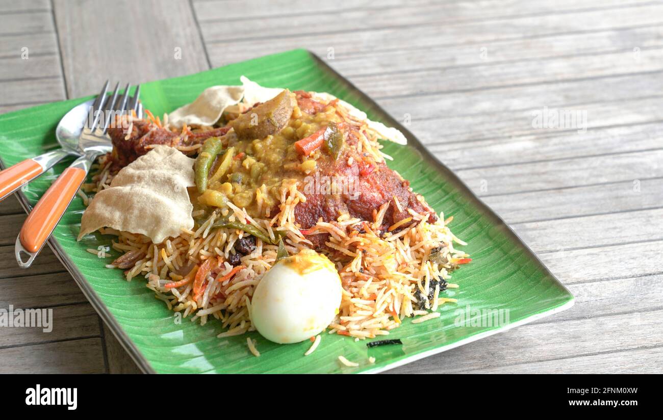 Huhn Briyani Reis auf dem Tisch. Indische Küche. Seitenansicht. Speicherplatz kopieren. Stockfoto