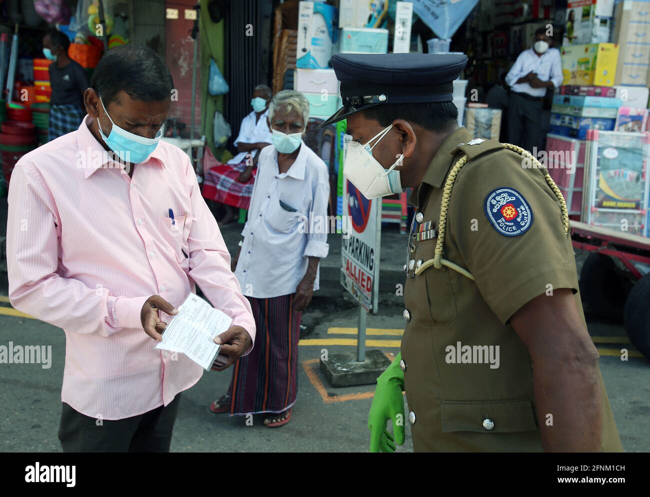 Colombo, Sri Lanka. Mai 2021. Ein Polizeibeamter überprüft Personalausweise, da die Behörden ein Ausweissystem einführen, um die Bewegung von Personen angesichts einer dritten Welle von COVID-19 in Colombo, Sri Lanka, 17. Mai 2021, zu beschränken. Quelle: Ajith Perera/Xinhua/Alamy Live News Stockfoto