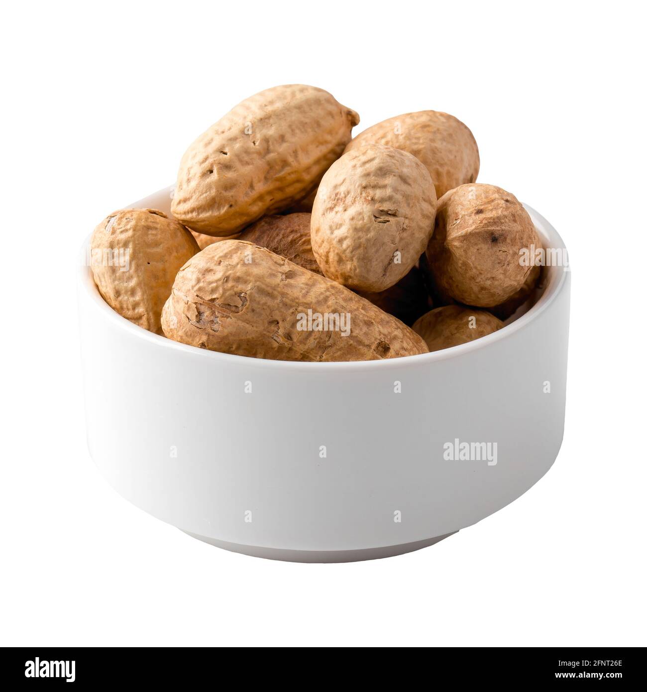 Isolierte Schale mit Erdnüssen in Schale auf weiß Stockfoto