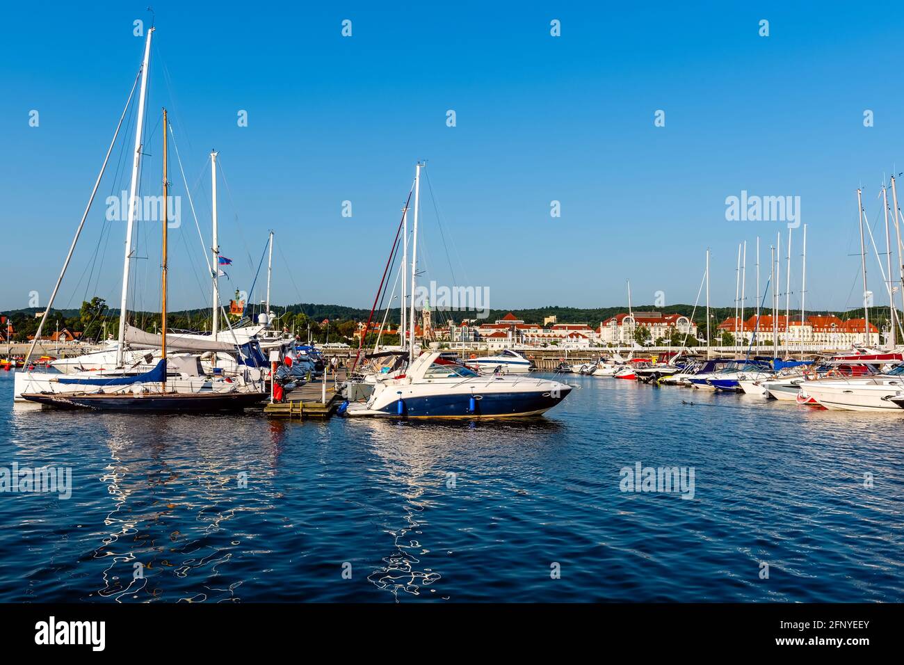 Segelyachten liegen an einem sonnigen Morgen an einem Pier in einem Hafen an der ostsee. Nautisches Schiff für Charter Stockfoto