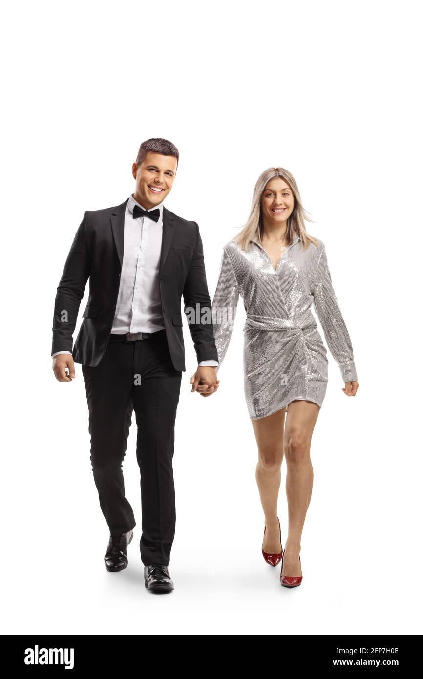 In voller Länge Porträt eines jungen eleganten Paares zu Fuß in Richtung Kamera und Hände isoliert auf weißem Hintergrund Stockfoto