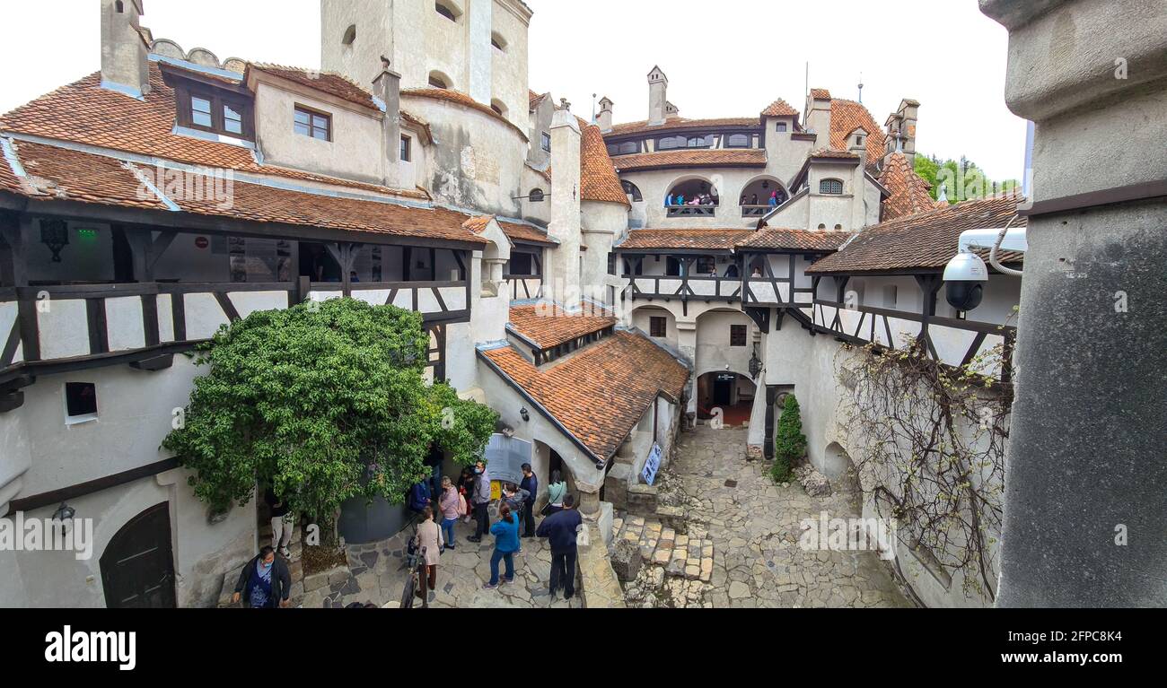 Bran, Romania - May 16, 2021: Tourists visit the Bran Castle, known also as Dracula’s Castle in Transylvania, Romania. Stockfoto