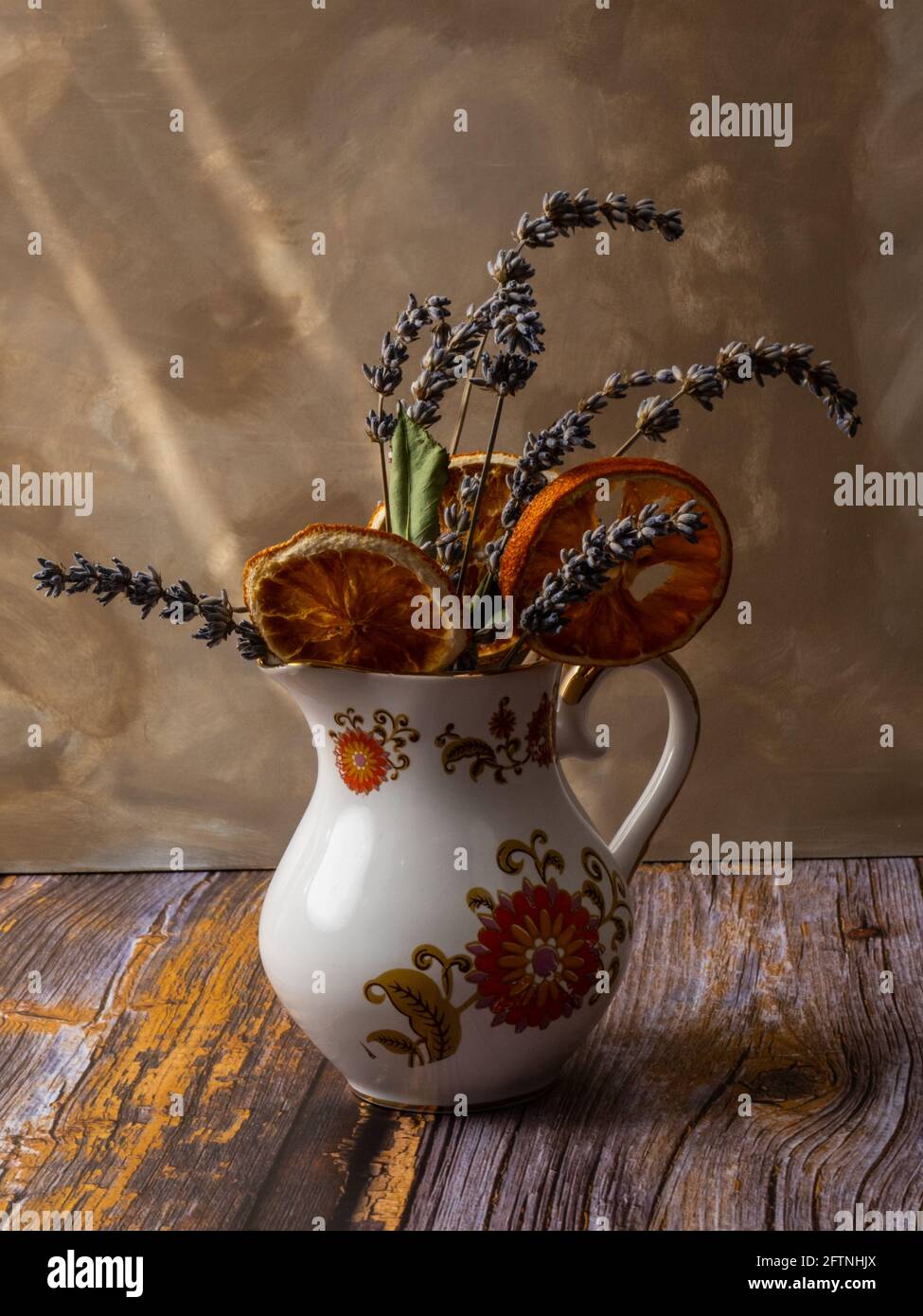 Lavendel und verdired orange Blumen auf weiß gemusterten Vase oben der vintage und braunen Hintergrund mit Holztisch, vintage Konzept Stockfoto