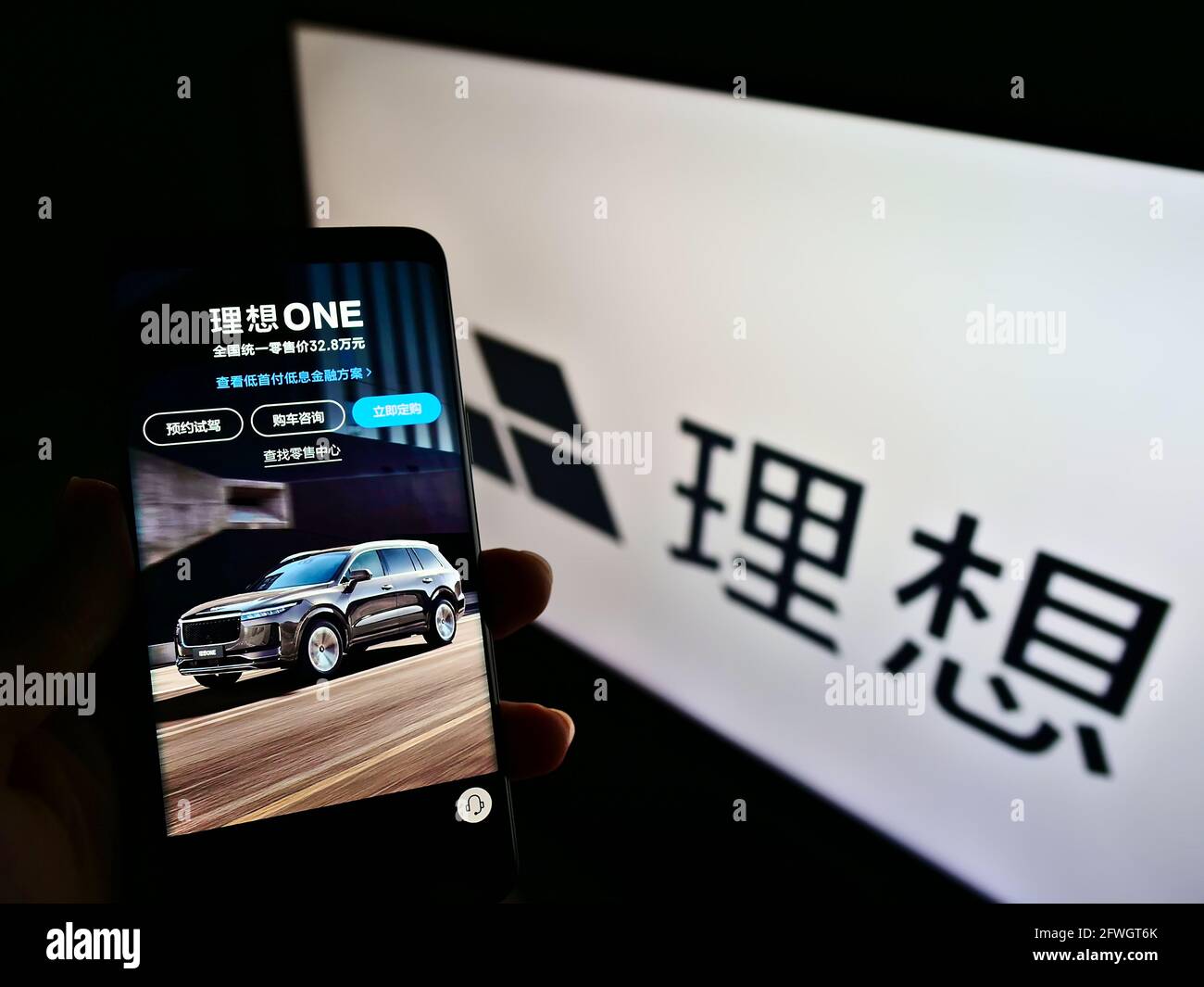 Person, die Smartphone mit Webseite des chinesischen Elektroauto-Herstellers Li Auto Inc auf dem Bildschirm mit Logo hält. Konzentrieren Sie sich auf die Mitte des Telefondisplays. Stockfoto