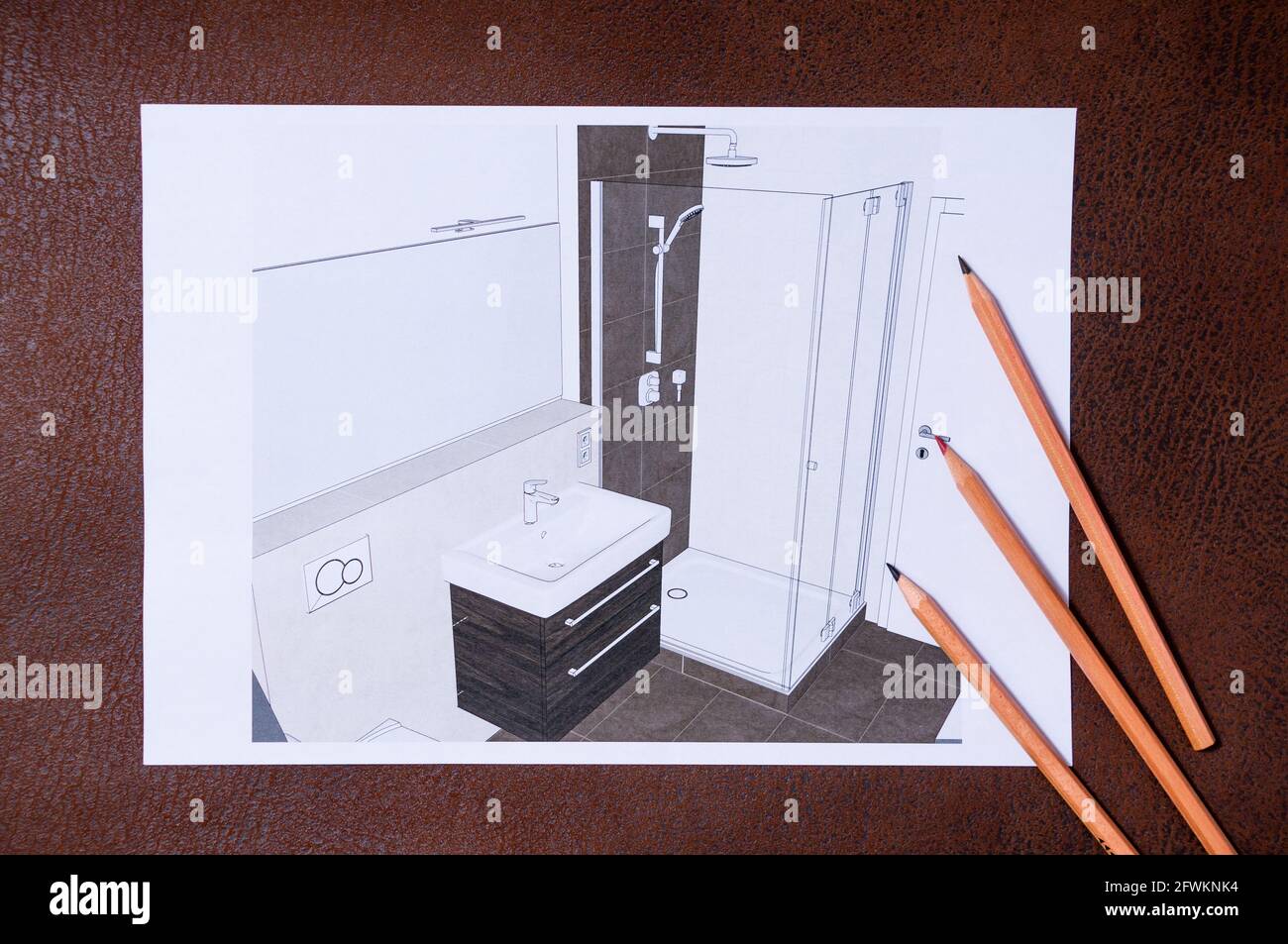Planung eines Badezimmers auf einer braunen Oberfläche. Es sind 3 Stifte darauf. Blick auf das Badezimmer von einer erhöhten Position Stockfoto