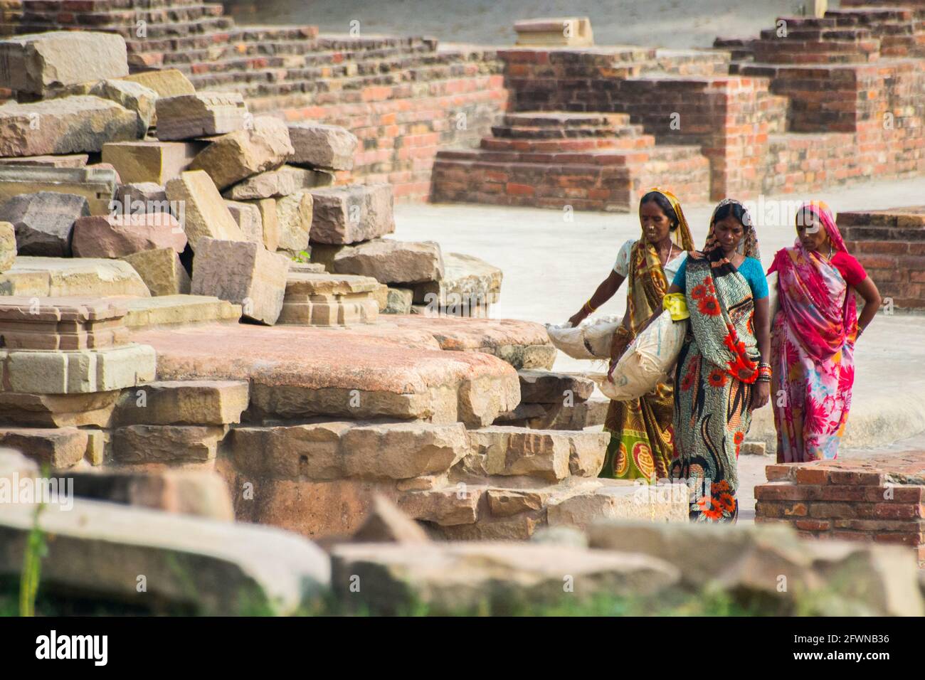 Sarnath, Indien. Arbeiter, die schwere Lasten tragen. Stockfoto