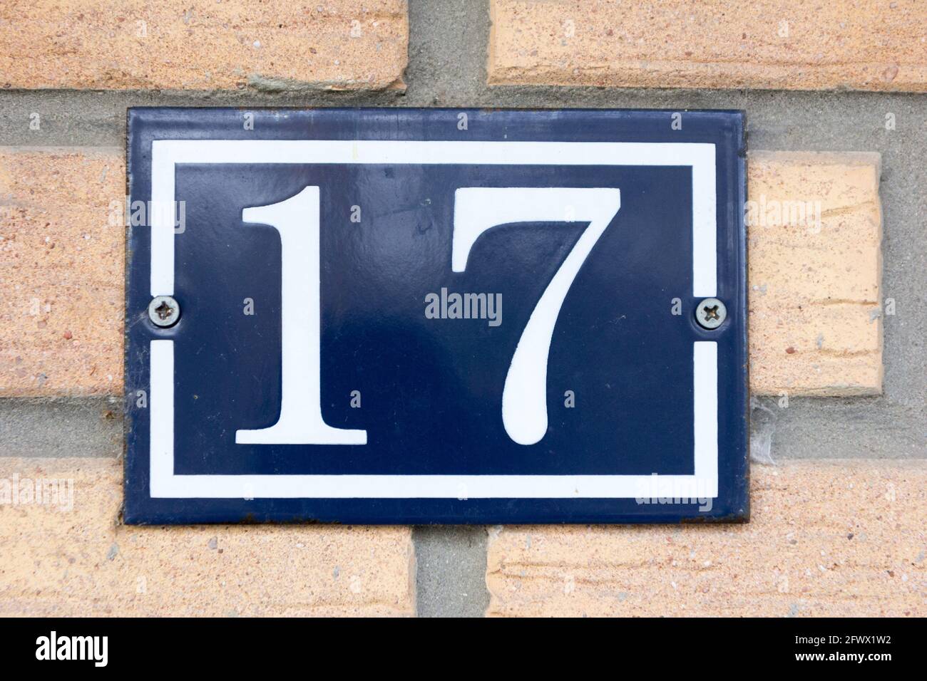 Nummer 17 in weiß auf einer blauen Metallplatte Stockfoto