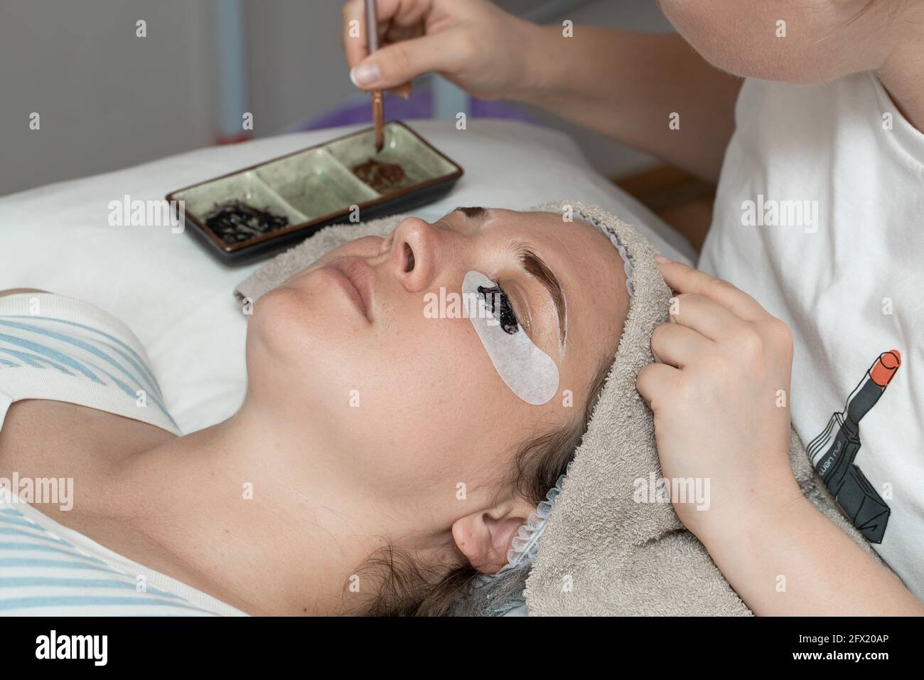 Augenbrauen und Wimpern in einem Schönheitssalon mit Henna einfärben. Stockfoto