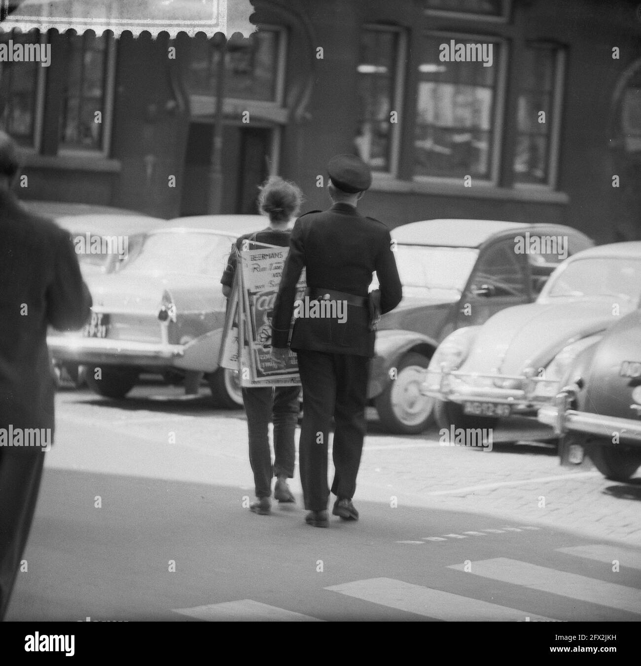 Mann mit Schild nach der Verhaftung. Gerichtsverfahren gegen Fälscher. Mädchen wird weggeführt, 21. Juni 1961, Fälscher, Verhaftungen, Schilder, Gerichtsverfahren, Niederlande, Foto der Presseagentur des 20. Jahrhunderts, zu erinnerende Nachrichten, Dokumentation, historische Fotografie 1945-1990, visuelle Geschichten, Menschliche Geschichte des zwanzigsten Jahrhunderts, Momente in der Zeit festzuhalten Stockfoto