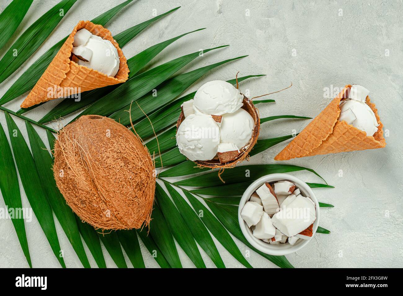 Draufsicht auf Kokos-Eiswaffelkegel auf grauem Hintergrund. Stockfoto