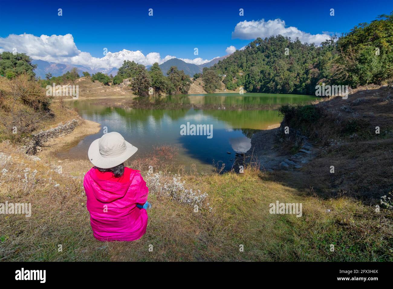 Alleinreisende, alleinreisende Frau, die die Schönheit von Deoria Tal, auch Devaria oder Deoriya Tal, See in Uttarakhand, Indien, beobachtet. Blauer Himmel Stockfoto