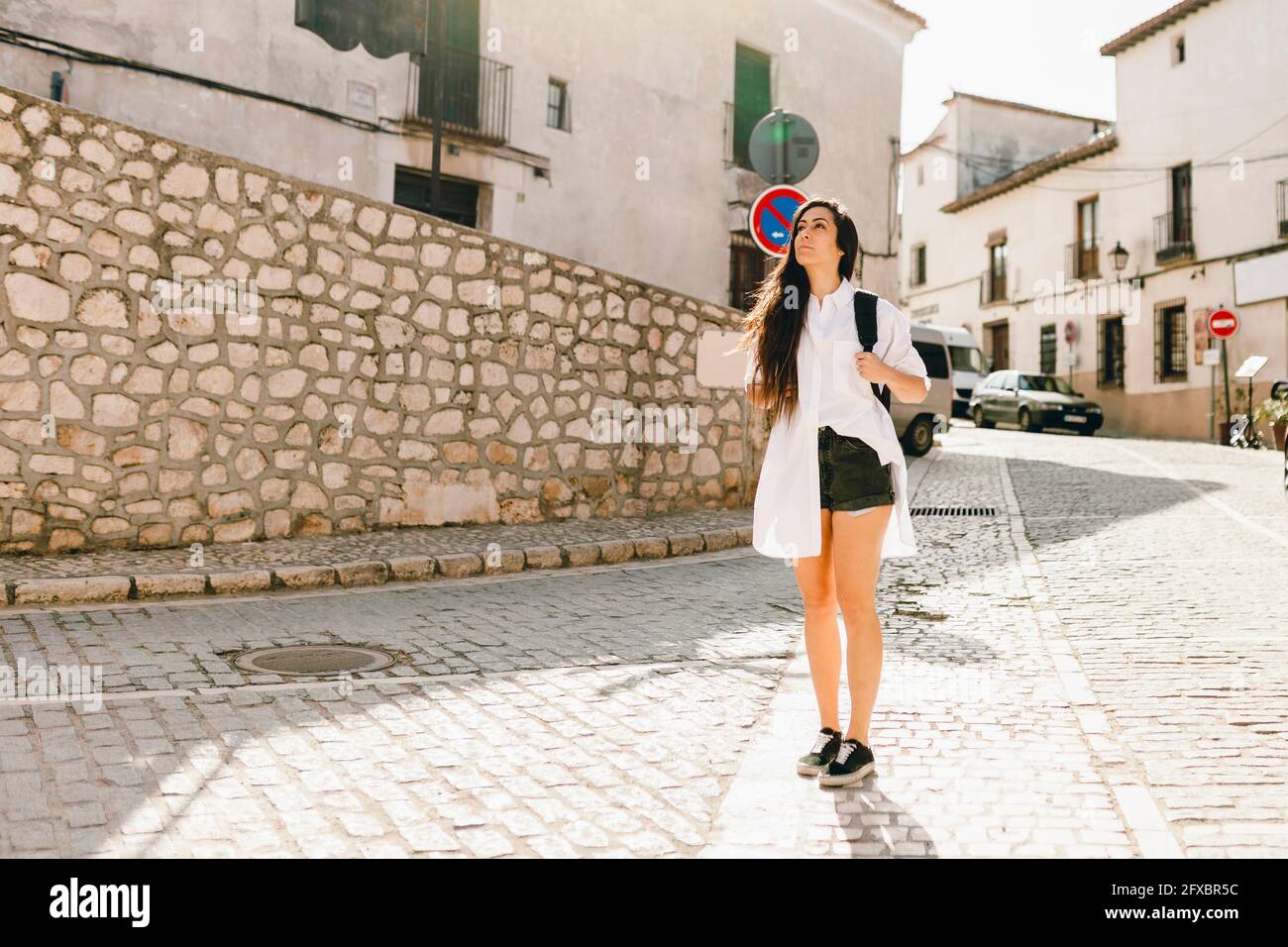 Weibliche junge Touristen, die an sonnigen Tagen auf der Straße stehen Stockfoto