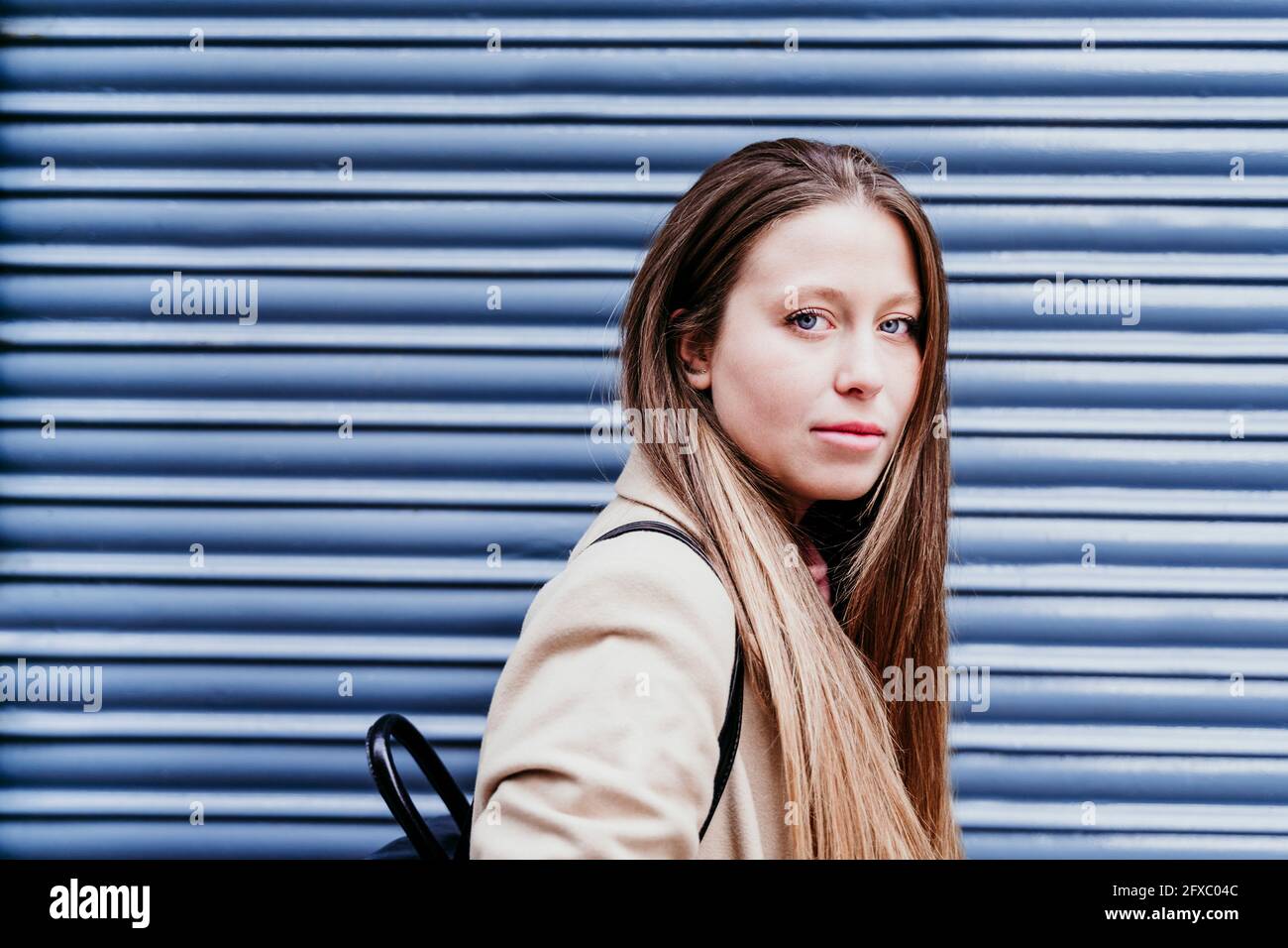 Junge Frau mit langen braunen Haaren durch Verschluss Stockfoto