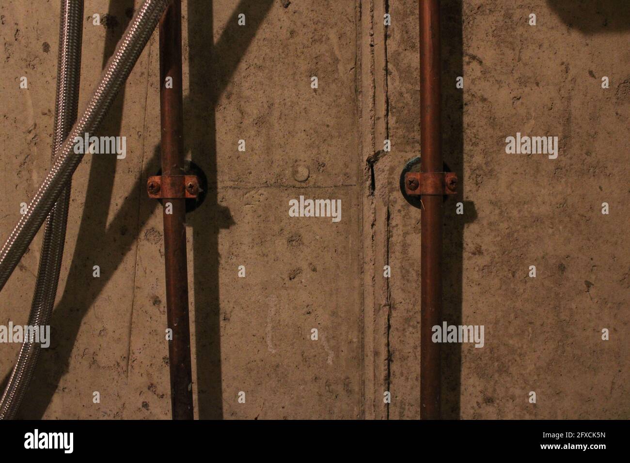 Kupferrohre eines Waschbeckens im Keller Stockfoto
