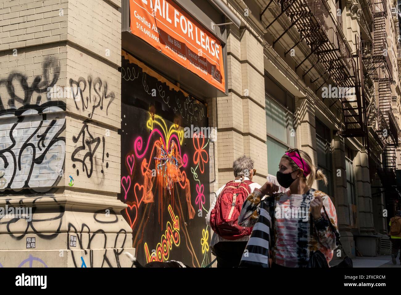 Maskierte und maskenlose Menschen im Viertel Flatiron in New York am Dienstag, den 25. Mai 2021. New York hat entspannte Maskenmandate, die es den meisten Outdoor-Aktivitäten erlauben, maskenfrei zu sein, sowie viele Innenräume, mit Einschränkungen. (© Richard B. Levine) Stockfoto