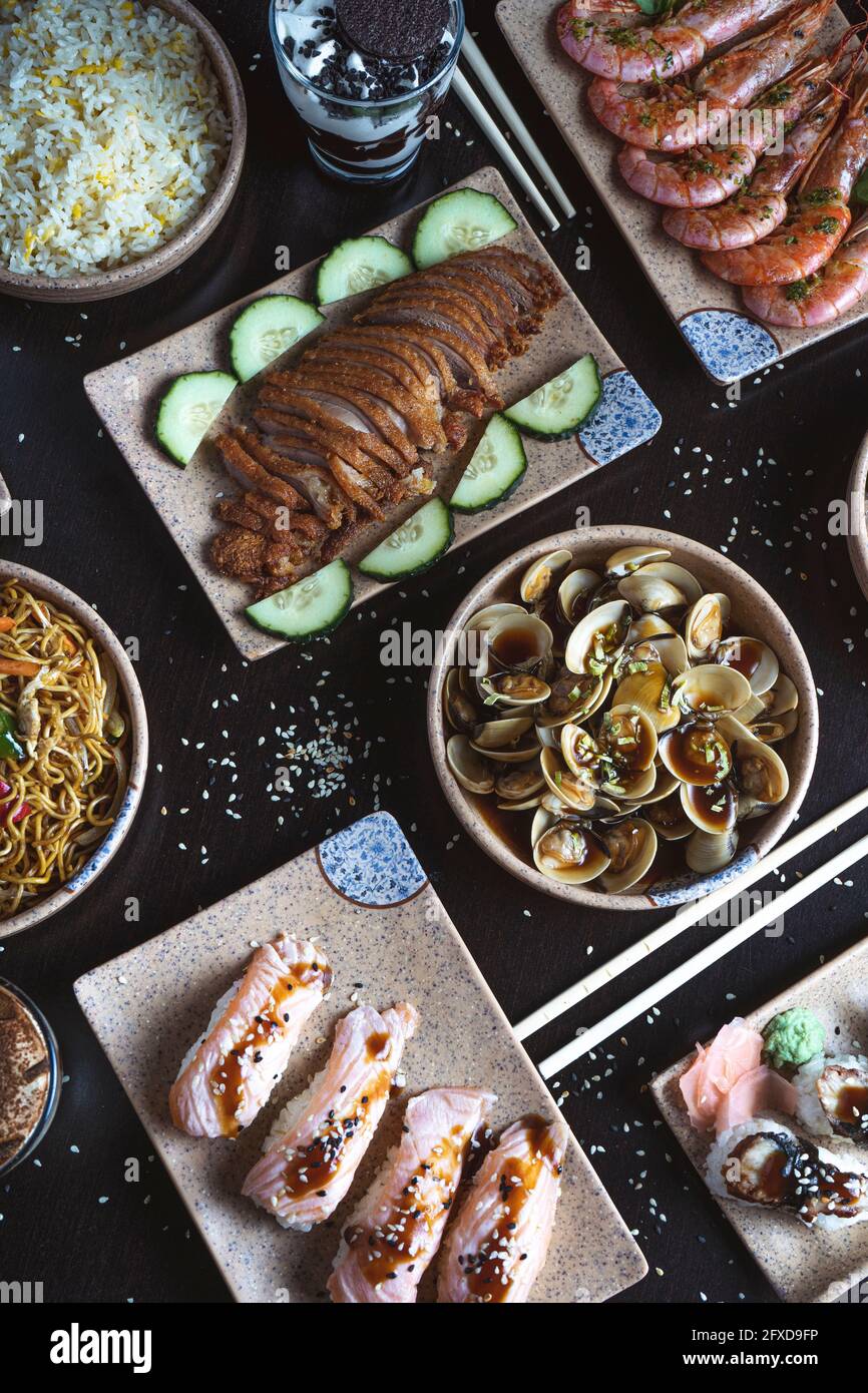 Blick von oben auf japanische Speisen, die auf dem Tisch serviert werden. Vertikales Bild Stockfoto