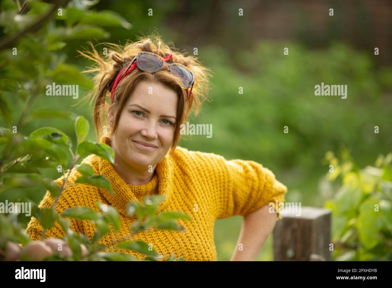 Portrait schöne glückliche Frau im Garten Stockfoto