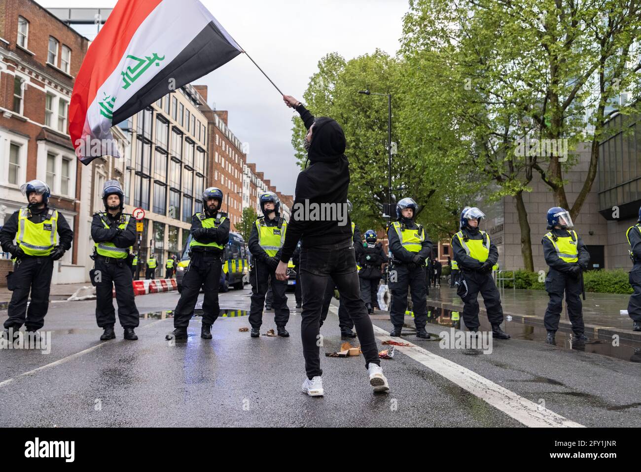 Protestler schwenkt irakische Flagge, während er sich in der Polizeikordon befindet, Free Palestine Protest, London, 22. Mai 2021 Stockfoto