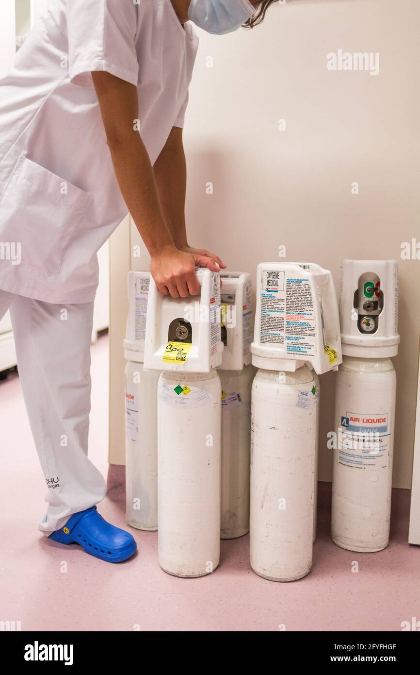 Eine Krankenschwester transportiert eine medizinische Sauerstoffflasche zu einer COVID-Krankenhausstation, CHU Limoges, Frankreich. Stockfoto