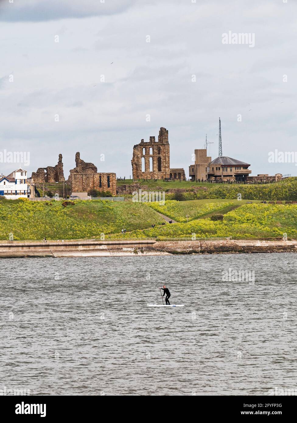Tynemouth Priory und Küstenwache mit Paddelboarder. Stockfoto