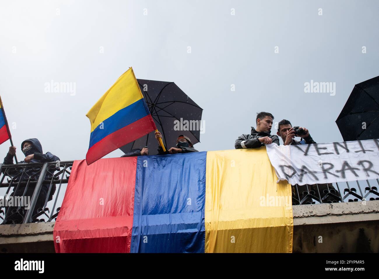 Im Rahmen der einmonatigen Gedenkfeier zum Beginn des nationalen Streiks in Kolumbien gegen die Regierung von Ivan Duque am 28. März 2021, schwingt der Protestler an einem neuen Protesttag in Bogotá die Flagge kolumbiens. Stockfoto