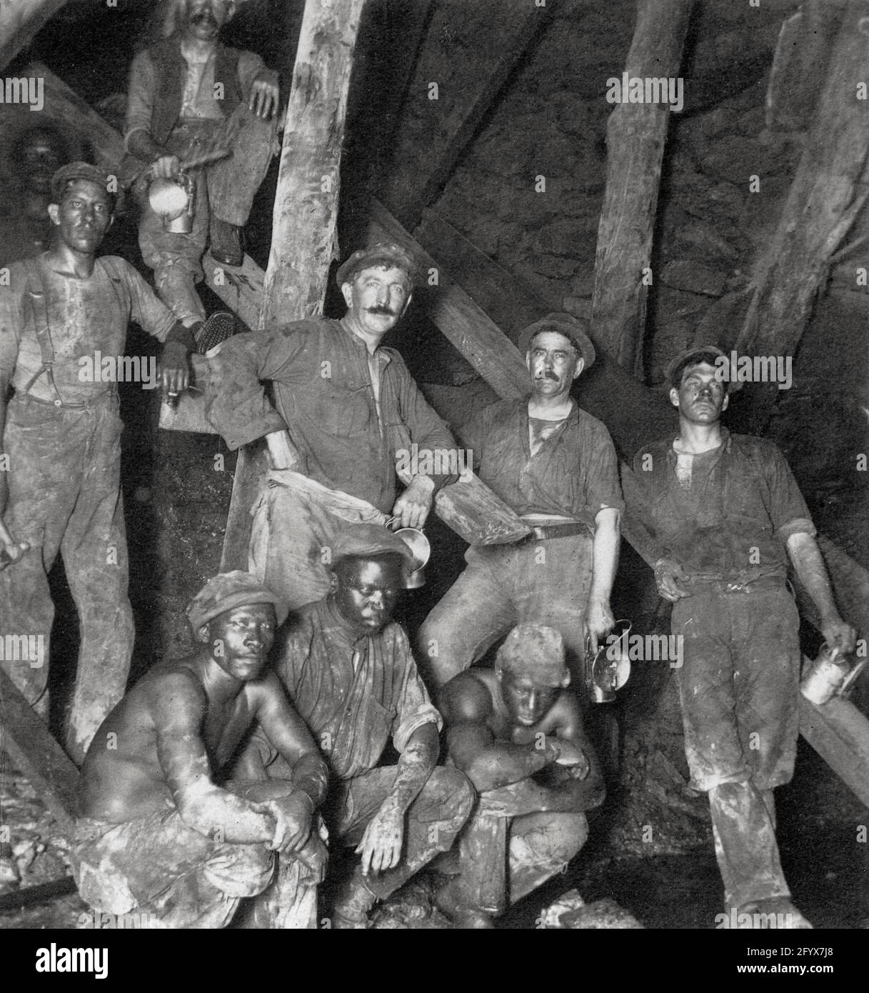 Schwarze Bergleute mit weißen Aufsehern, Goldmine bei Johannesburg, Südafrika um 1920 Stockfoto