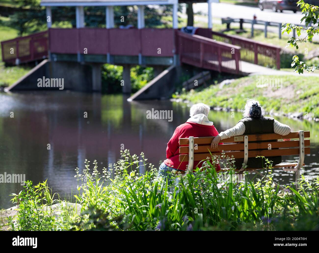 Zwei Freunde sitzen auf einer Parkbank Stockfoto