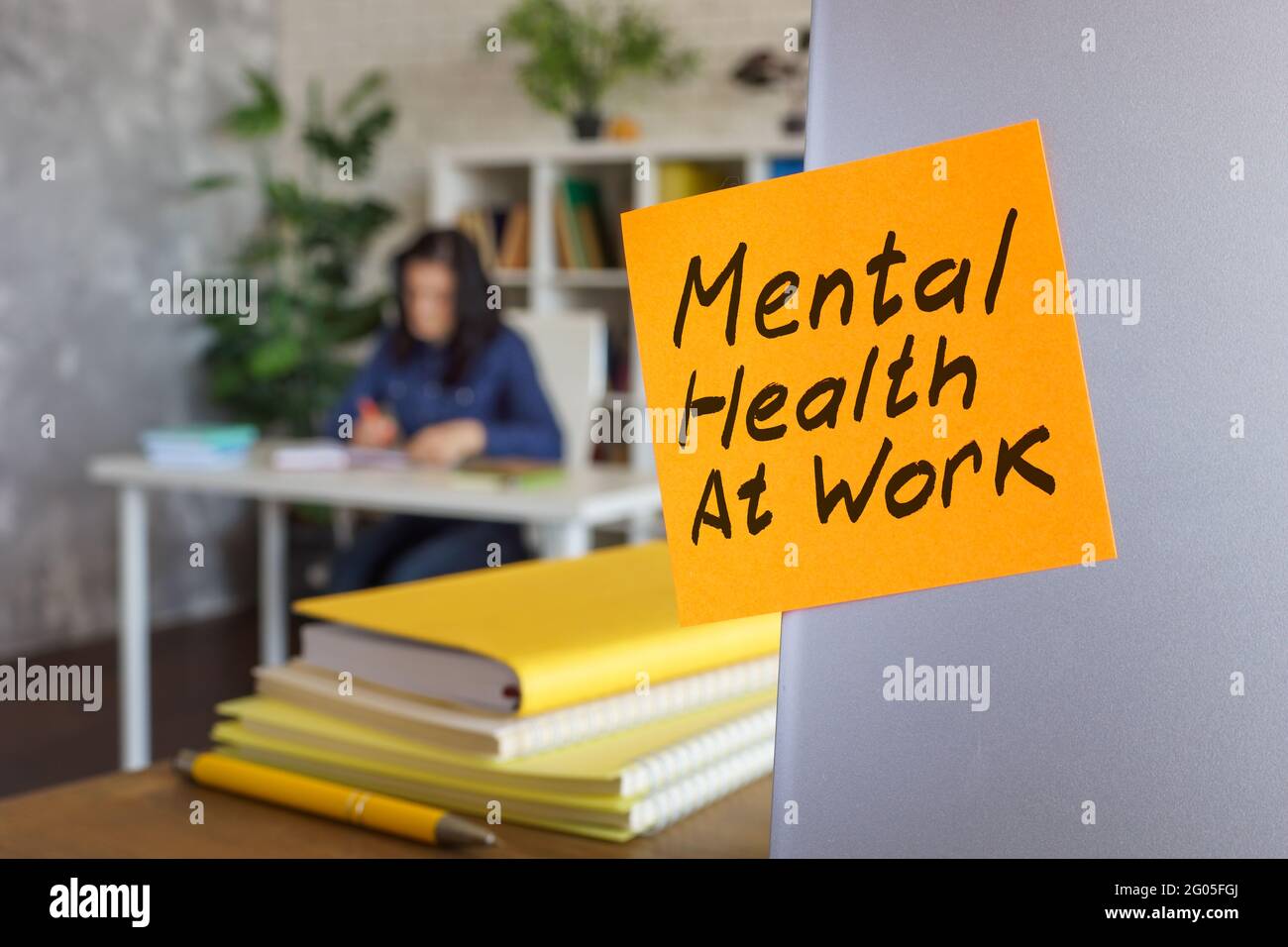 Schild „psychische Gesundheit am Arbeitsplatz“ auf dem Aufkleber auf dem Laptop. Stockfoto