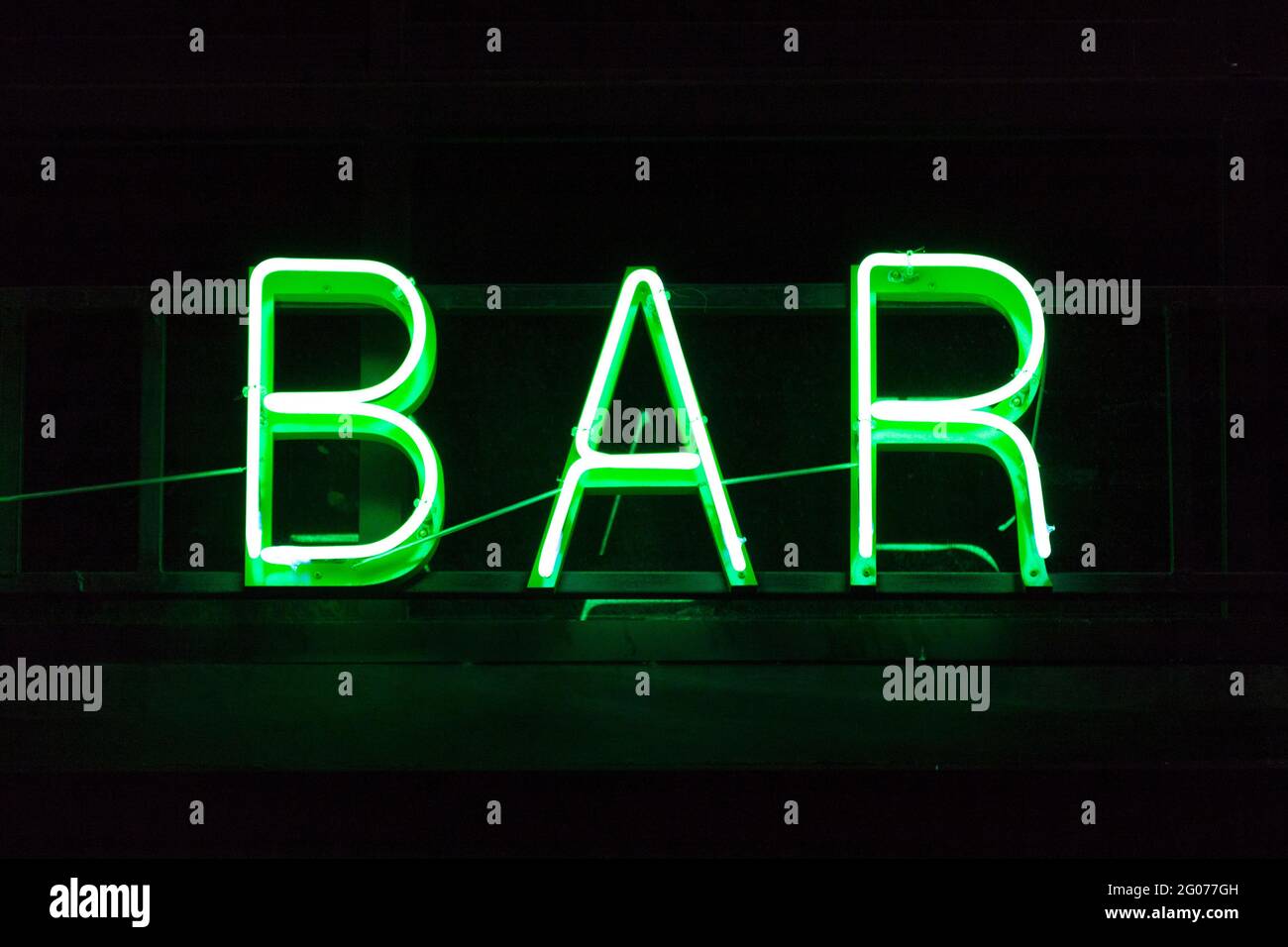 Nahaufnahme eines grünen Neonlichts in Form des Wortes „Bar“. Stockfoto