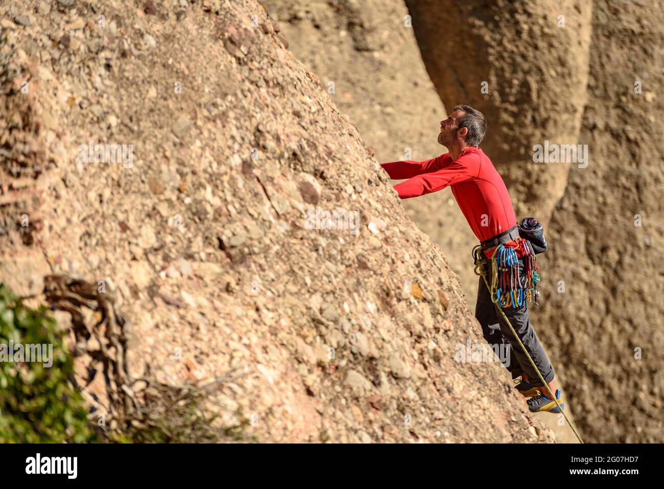 Ein Bergsteiger, der auf den Felsen von Elefant steigt, neben der Einsiedelei von Sant Salvador de Montserrat (Barcelona, Katalonien, Spanien) Stockfoto