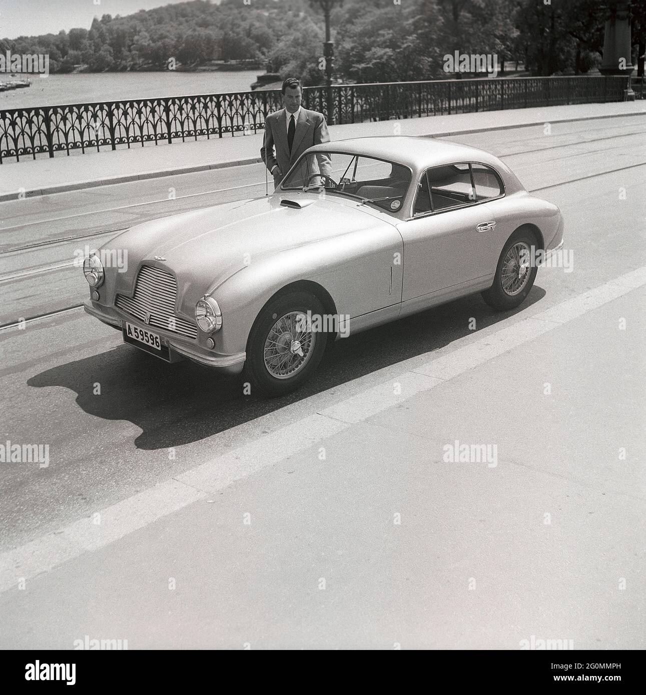 Fahren in den 1950er Jahren. Ein Mann neben seinem Auto, ein Aston Martin DB2. Dieses Modell wurde 1950 vorgestellt und in 411 Fahrzeugen produziert. Er hatte einen Sechszylindermotor, vier Gänge und einen von Frank Feeley entworfenen Chassi. Schweden 1953. ref. BL108-9 Stockfoto