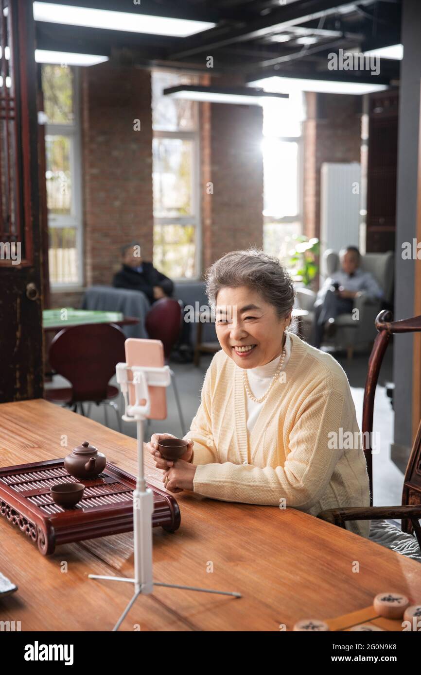 Glückliche alte Menschen nutzen Handys, um Videos zu sehen Stockfoto