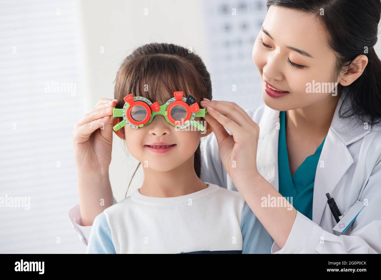 Optometristen des kleinen Mädchens testen die Sehschärfe Stockfoto