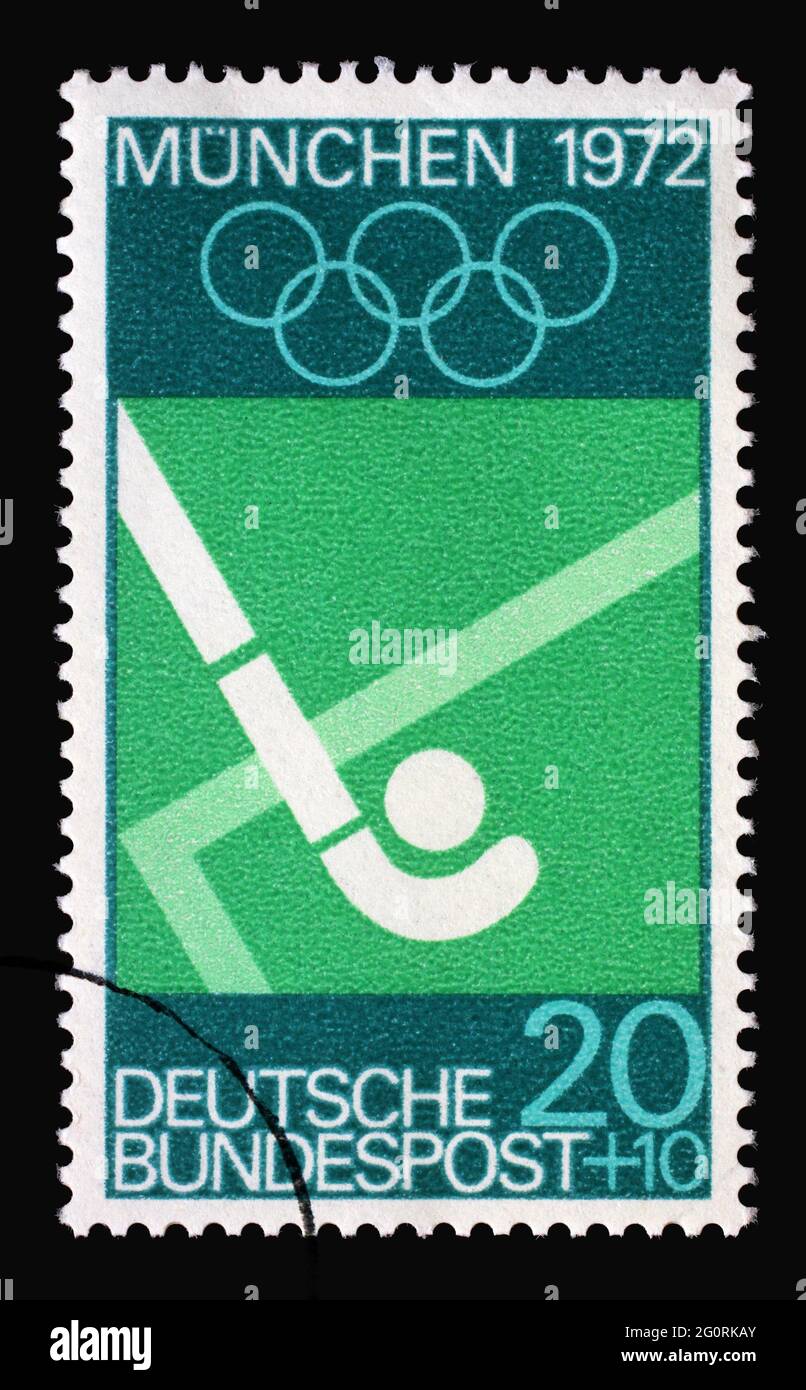 Die in Deutschland gedruckte Marke zeigt Hockey und Olympische Ringe, Olympische Sommerspiele 1972 in München, um 1969 Stockfoto