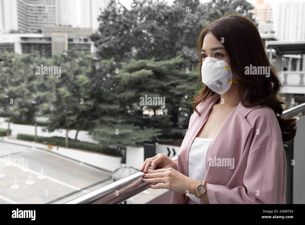 Asiatische Frau trägt eine schützende Gesichtsmaske für Pest Coronavirus. Hygienische Gesichtsmaske für die Sicherheit im Freien Umweltbewusstsein oder Virusverbreitung con Stockfoto