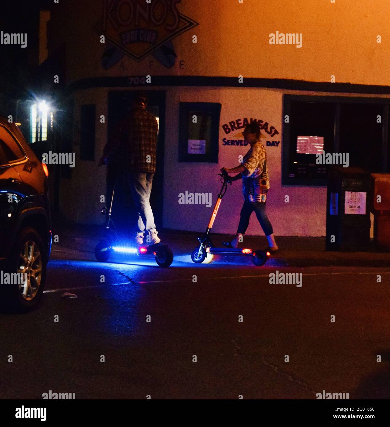 SAN DIEGO, CA., USA - 25. Mai 2021: Ein Foto von zwei Personen, die nachts in San Diego auf einem beleuchteten Neon-Roller fahren - 2021. Mai Stockfoto