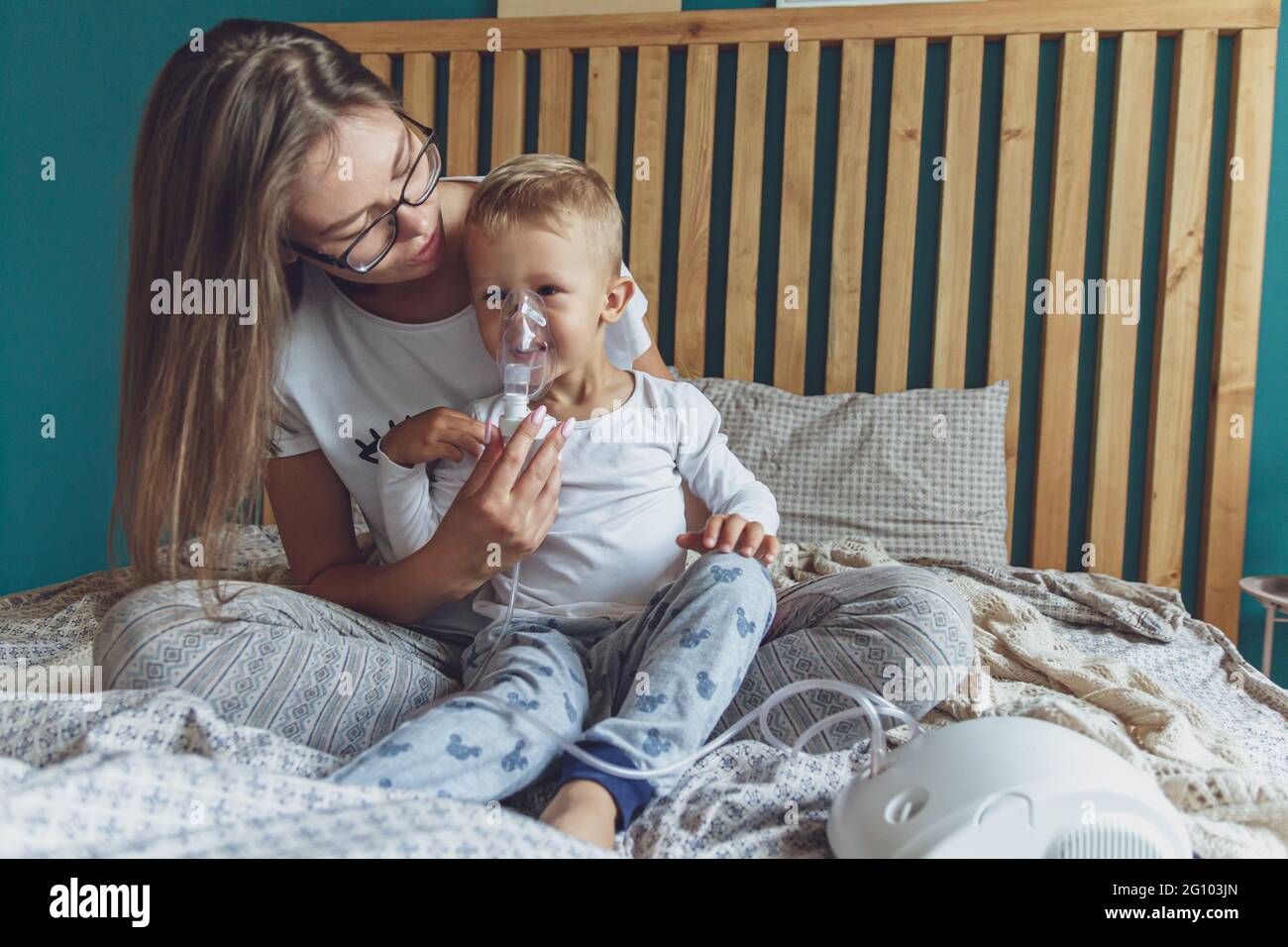 Frau mit Sohn macht Inhalation mit Vernebler zu Hause Stockfoto