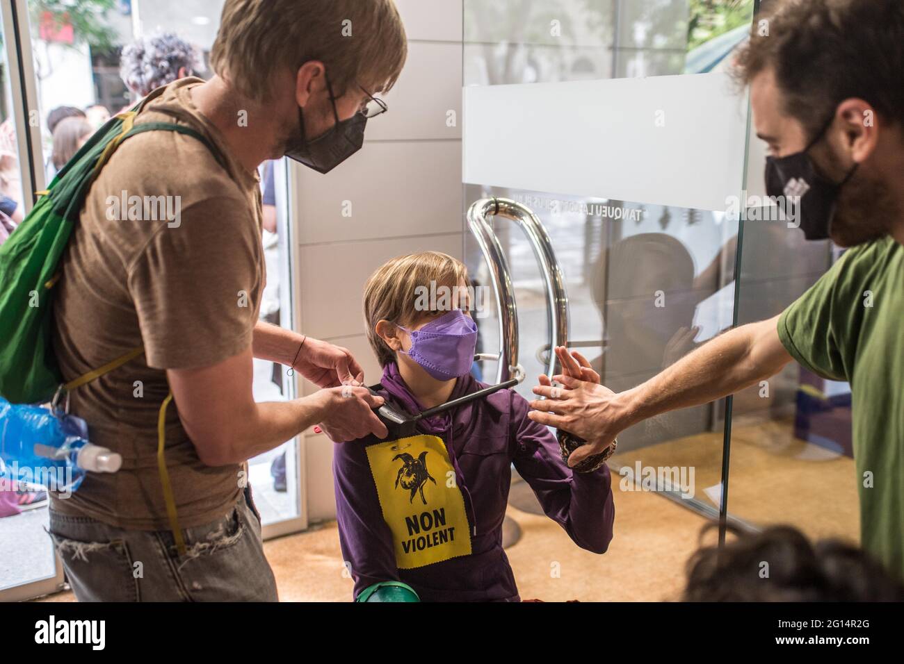 Barcelona, Spanien. Juni 2021. 4. Juni 2021, Barcelona, Katalonien, Spanien: XR-Aktivisten haben gesehen, wie sie die Kette aus dem Nacken der AktivistInnen entfernt haben.die UmweltaktivistInnen des Extinction Rebellion von Barcelona haben das Ministerium für Umwelt und nachhaltige Entwicklung Kataloniens besetzt. Eine Gruppe von Menschen hat sich an den Eingang des Gebäudes angekettet, um von der Ministerin für Klimapolitik, Ernährung und ländliche Agenda, Teresa Jorda, die Verpflichtung zu fordern, eine Bürgerversammlung für Klima in den katalanischen Gebieten zu schaffen, während andere Aktivisten die Straße draußen abgeschnitten haben. Kredit: ZUMA Press, Inc Stockfoto