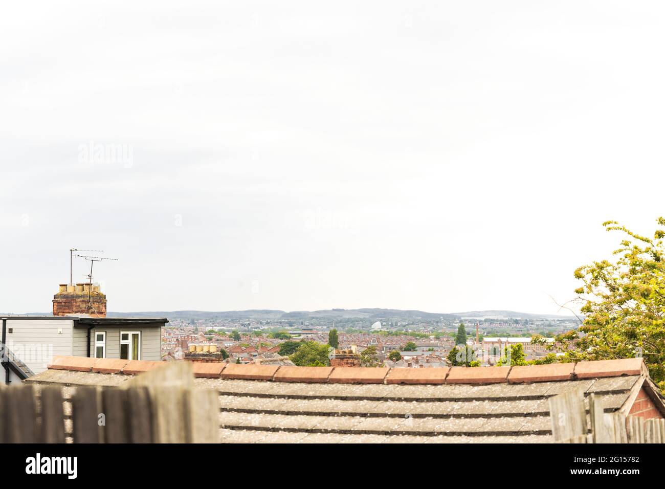 Die Dächer der Häuser und die Skyline von Leicester. Zeigt Humberstone und Anstey Gebiete, dann Charnwood Forest, Bradgate Park und Old John Tower in den Hügeln. Stockfoto