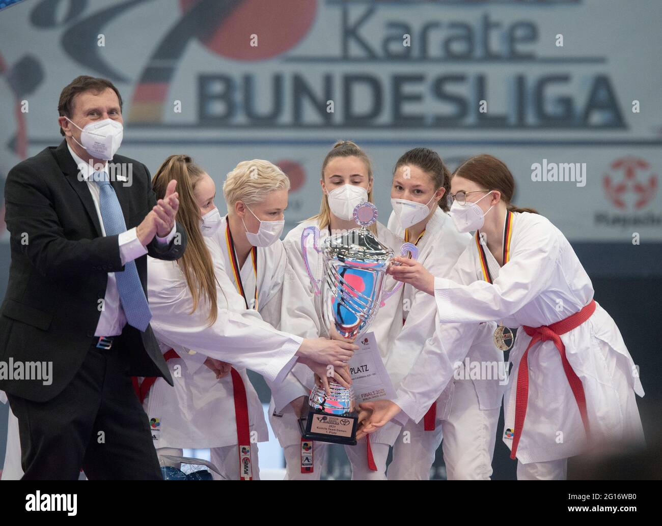 Dortmund, Deutschland. Juni 2021. Finale 2021 - Karate, Kumite Team Finale Frauen in der Helmut Körnig Halle: Amelie Lücke (l-r), Charlotte Grimm, Michaela Queck, Madelene Schröter und Reene Stein von Musashi Weimar feiern den Sieg. Links Wolfgang Weigert, Präsident des Deutschen Karate-Bundes. Quelle: Bernd Thissen/dpa/Alamy Live News Stockfoto