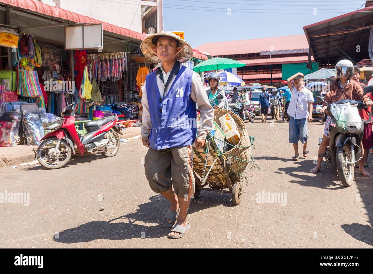 Man Wheeling kauft auf dem Outdoor-Markt in Pakse, Laos Stockfoto