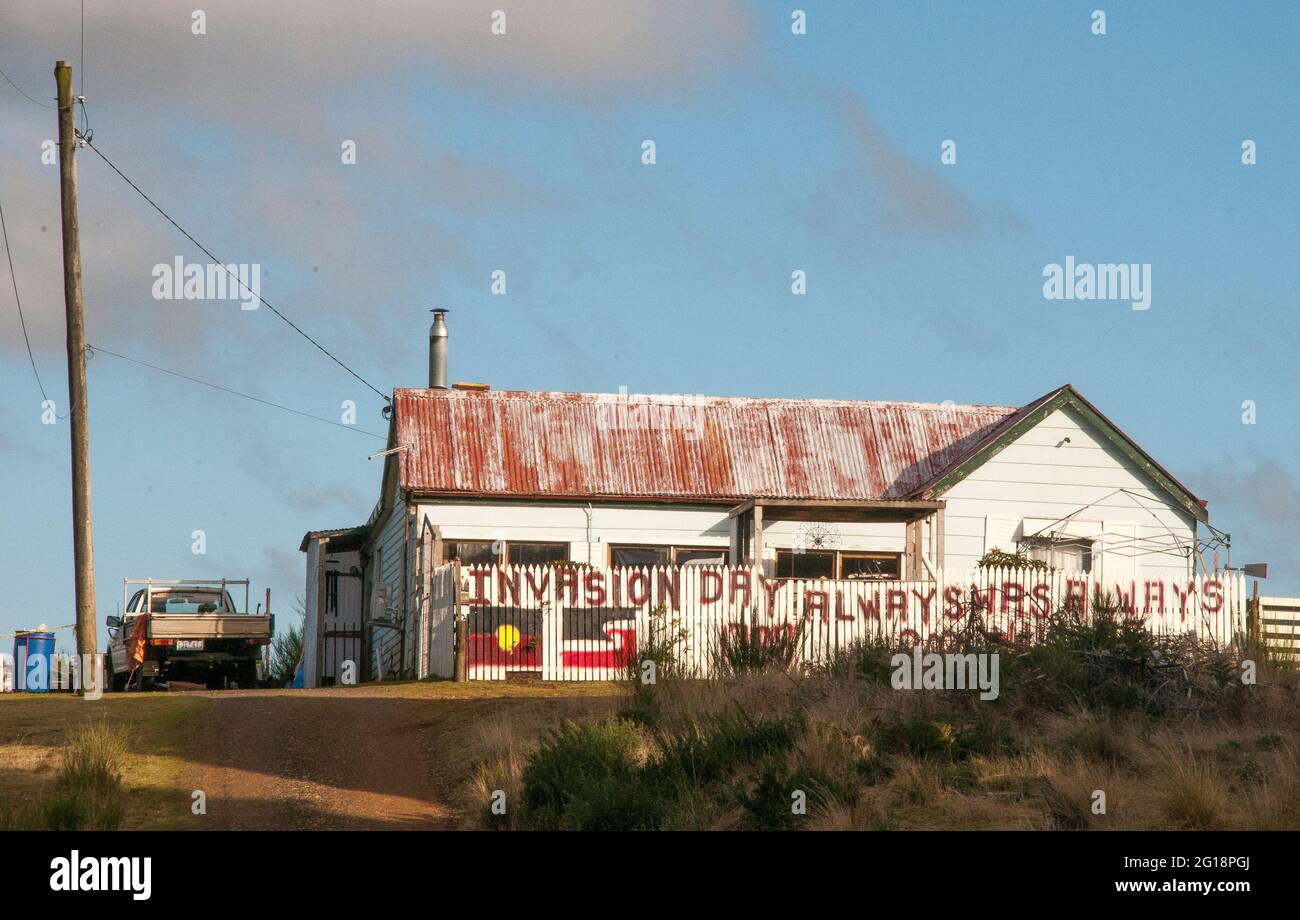 „Invasion Day“-Protestslogans der Aborigines, die auf einem vernachlässigten Haus in Waratah, im Nordwesten Tasmaniens, Australien, gehauen wurden Stockfoto