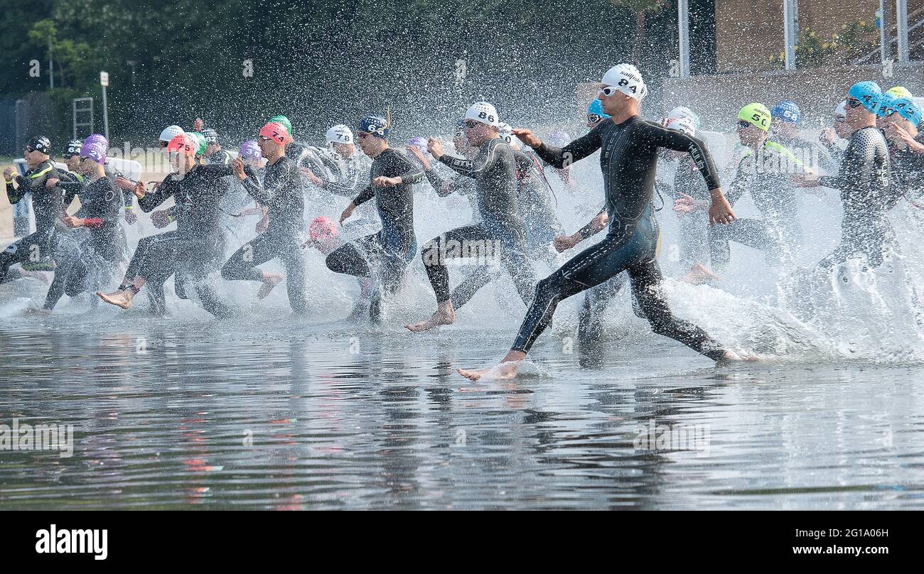 Berlin, Deutschland. Juni 2021. Triathlon: Deutsche Meisterschaft, Sprint, Männer: Die Athleten laufen nach dem Startschuss ins Wasser des Wannsee. Marcel Lehmberg vom LTV Erfurt startet mit Startnummer 84 ins Rennen. Quelle: Paul Zinken/dpa-Zentralbild/dpa/Alamy Live News Stockfoto