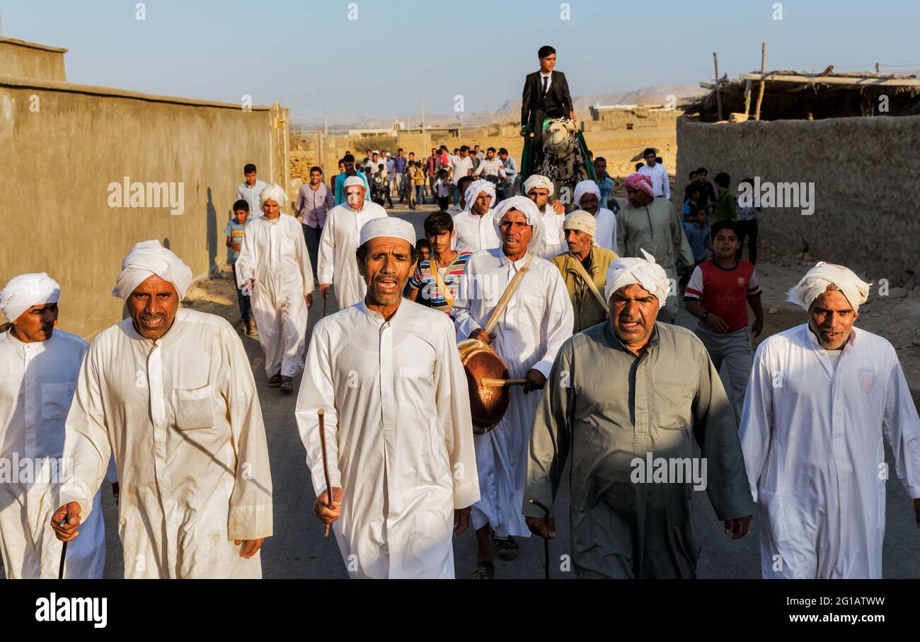 Bräutigam reitet auf einem Kamel während seiner traditionellen Hochzeitszeremonie im Norden der Insel Qeshm. Stockfoto
