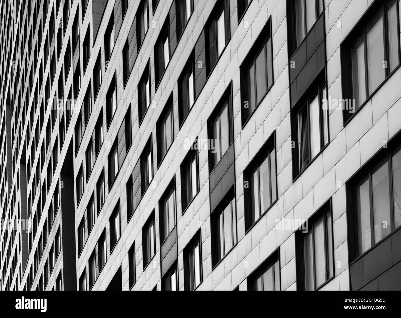 Fassade eines modernen Gebäudes. Hintergrund mit Reihen von Glasfenstern.Schwarz-Weiß-Bild Stockfoto