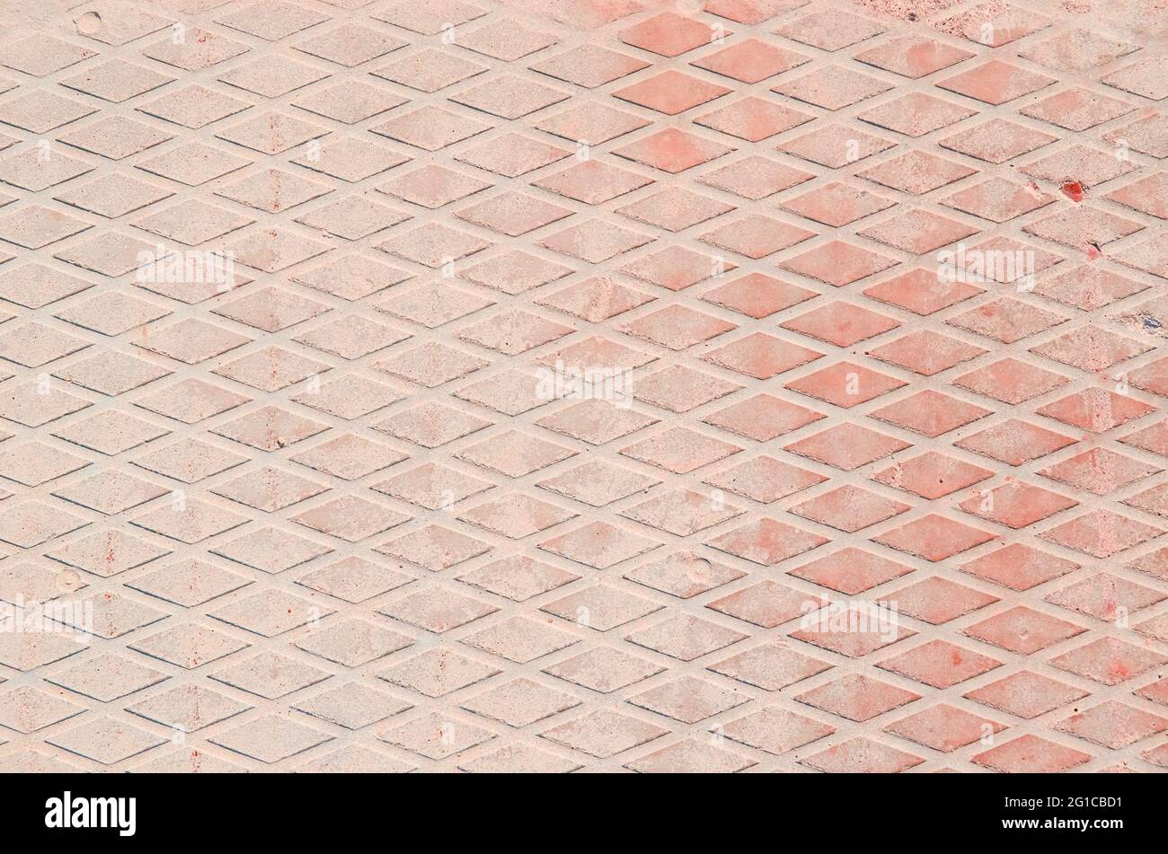 Blassrosa Beton mit Rautenmuster. Hintergrund. Stockfoto