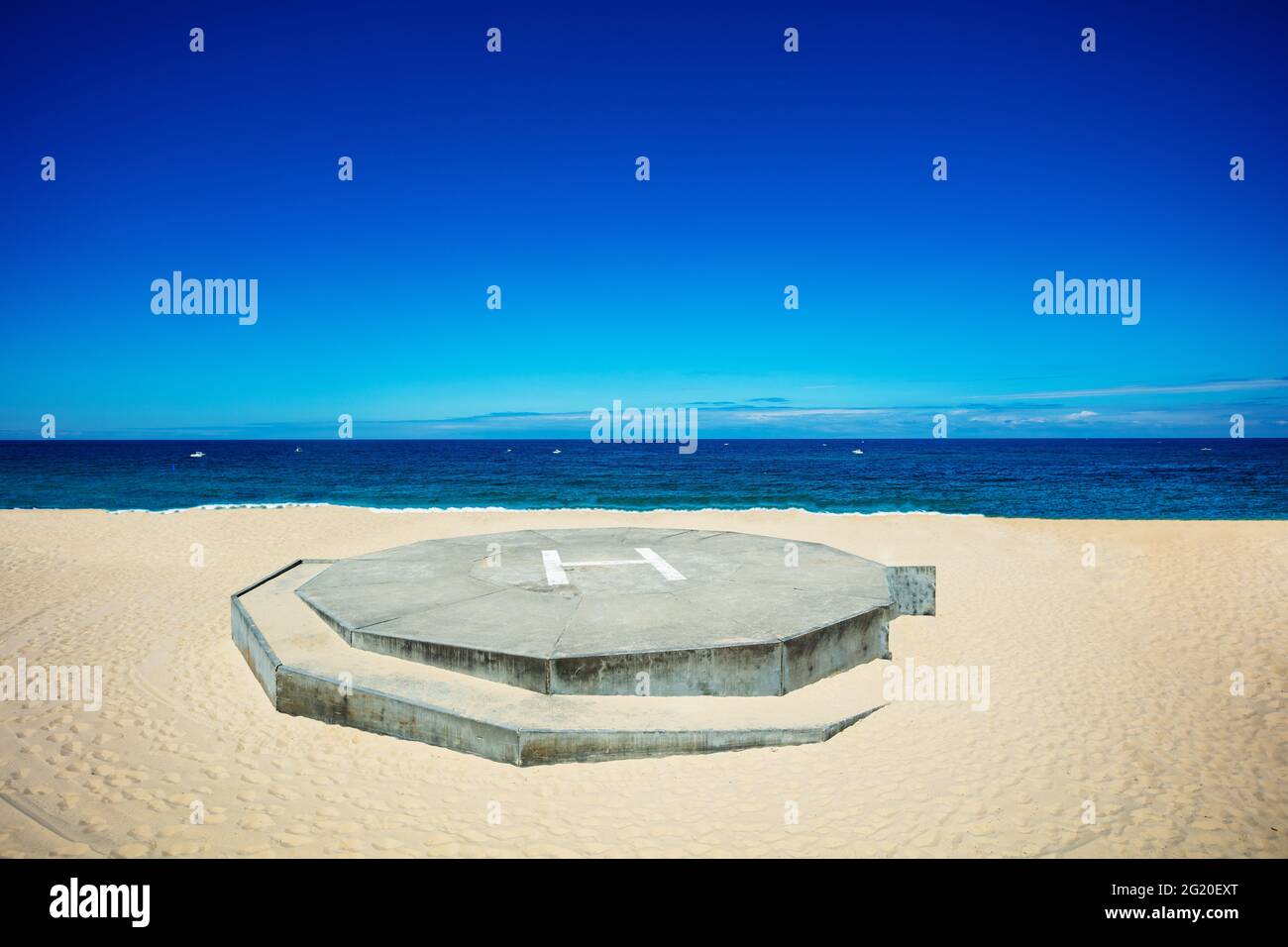 Blick auf den Hubschrauberlandeplatz auf den Sandstrand über das blaue Meer Stockfoto