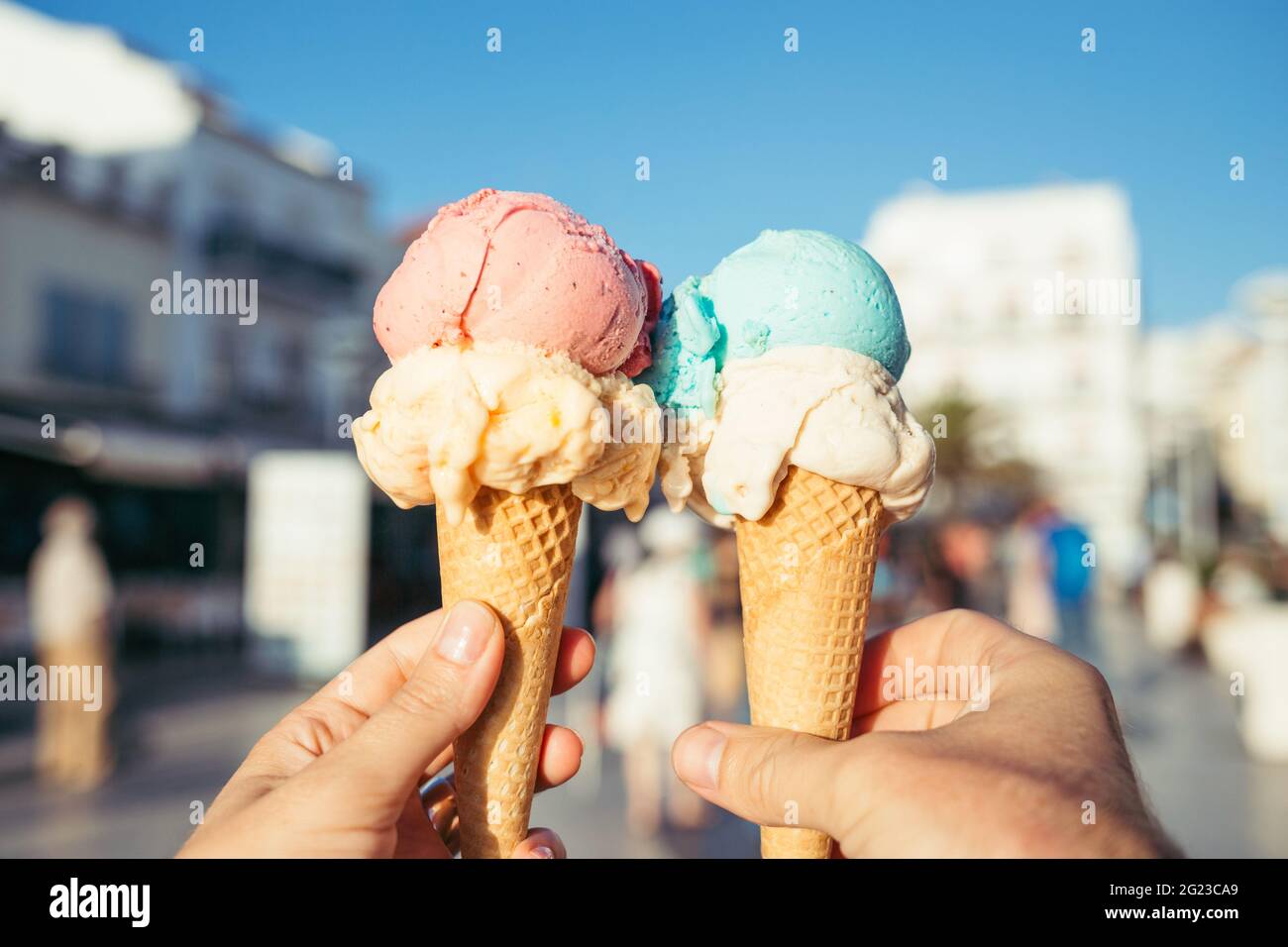 Hände mit Eiscreme in Waffelkonen. Stockfoto